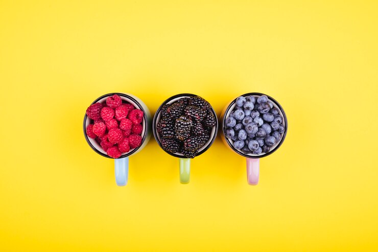 Cute assortment of forest fruits viewed from above, including strawberries, blueberries, and raspberries, perfect for a no sugar diet.