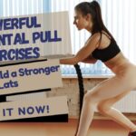 Fit woman doing horizontal pull exercises with ropes in a gym.